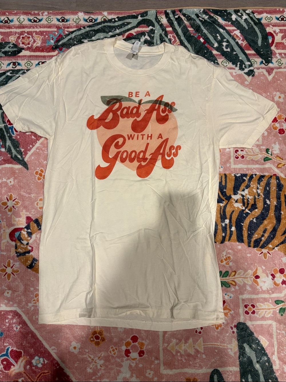 Next Level Apparel Cream Tee with Orange Retro Script